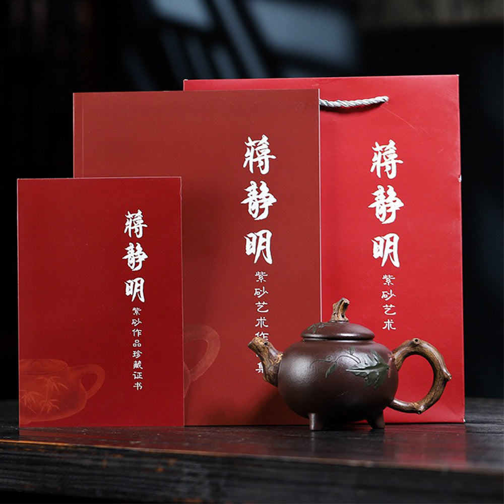 Elegant purple clay teapot with three-legged base and lid detail, perfect for gift giving