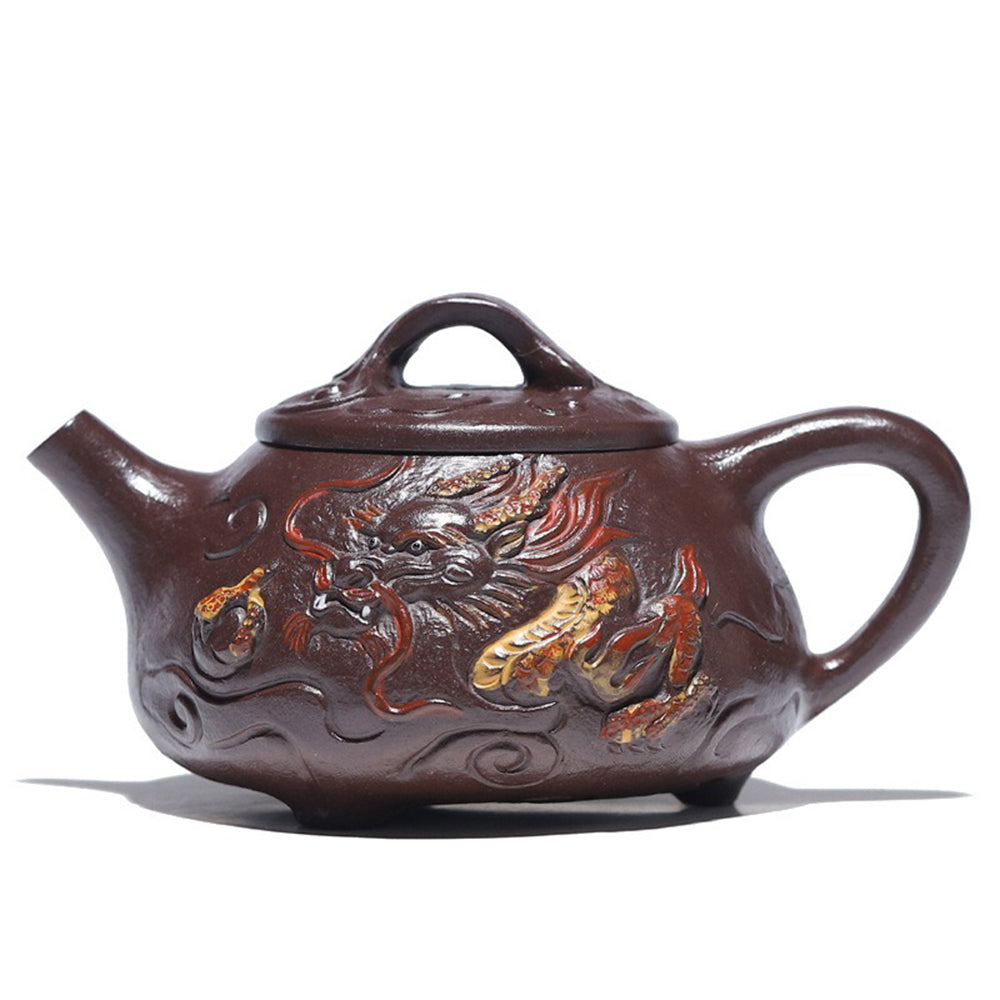 Handmade Yixing purple clay dragon teapot featuring detailed carvings and ergonomic handle.