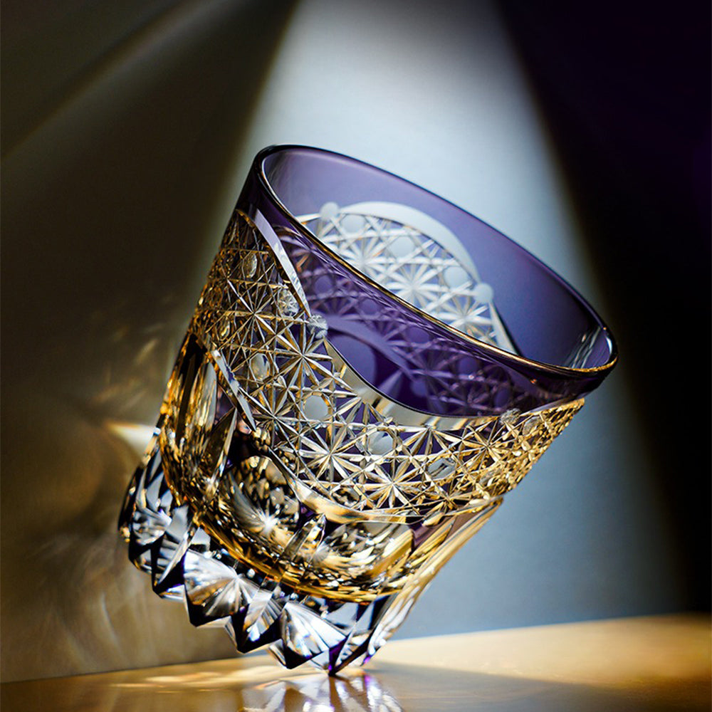 Edo Kiriko glass cup held in hand, demonstrating its size and elegance.