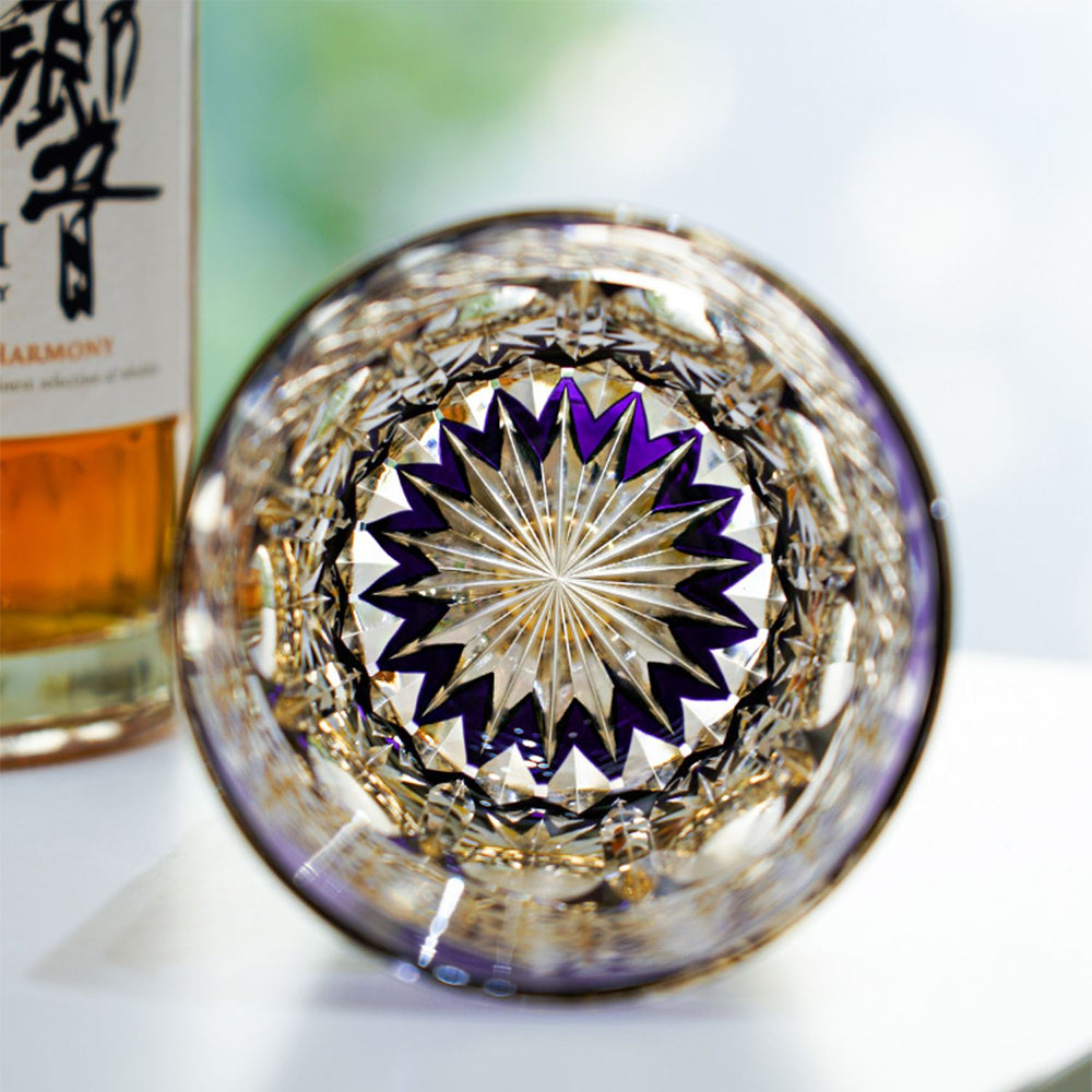 Edo Kiriko glass cup held in hand, demonstrating its size and elegance.