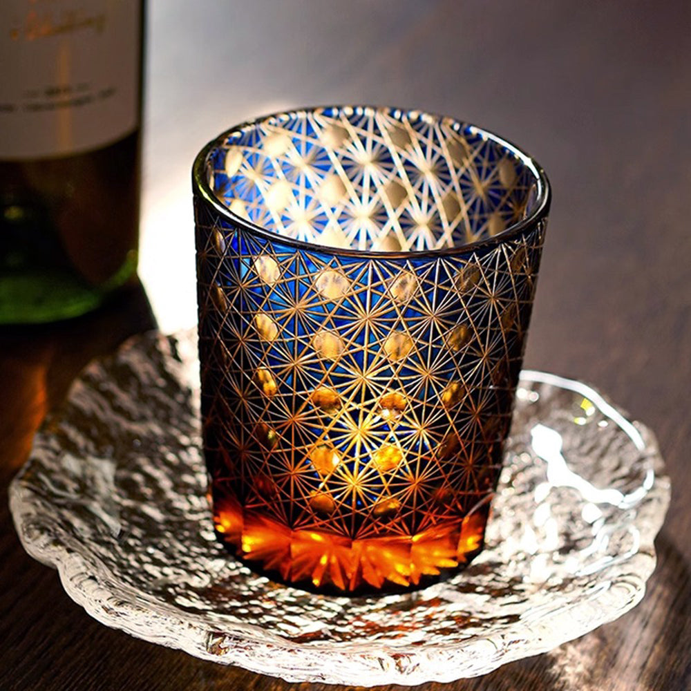 Elegant Edo Kiriko amber whiskey glass with chrysanthemum geometric patterns, showcasing traditional craftsmanship.