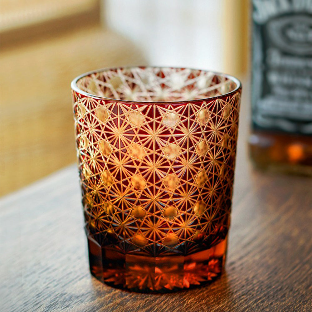 Elegant Edo Kiriko amber whiskey glass with chrysanthemum geometric patterns, showcasing traditional craftsmanship.