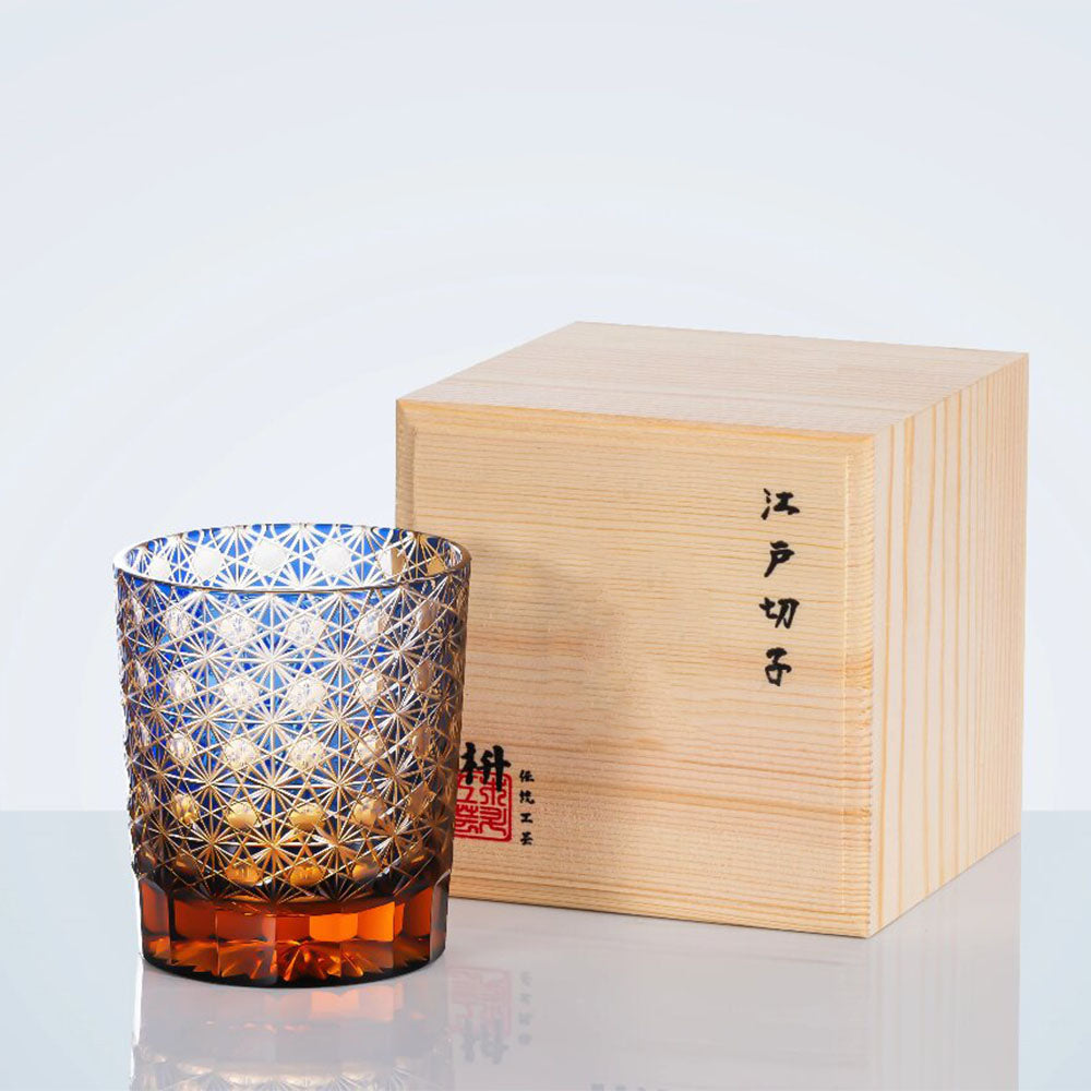 Elegant Edo Kiriko amber whiskey glass with chrysanthemum geometric patterns, showcasing traditional craftsmanship.