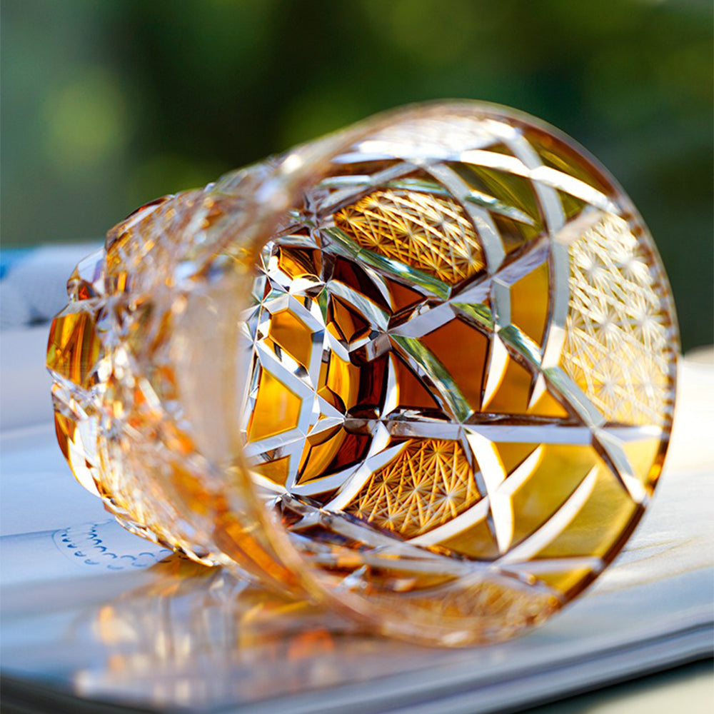 Whiskey poured into the artistic Japanese glass, highlighting vibrant amber and gold hues