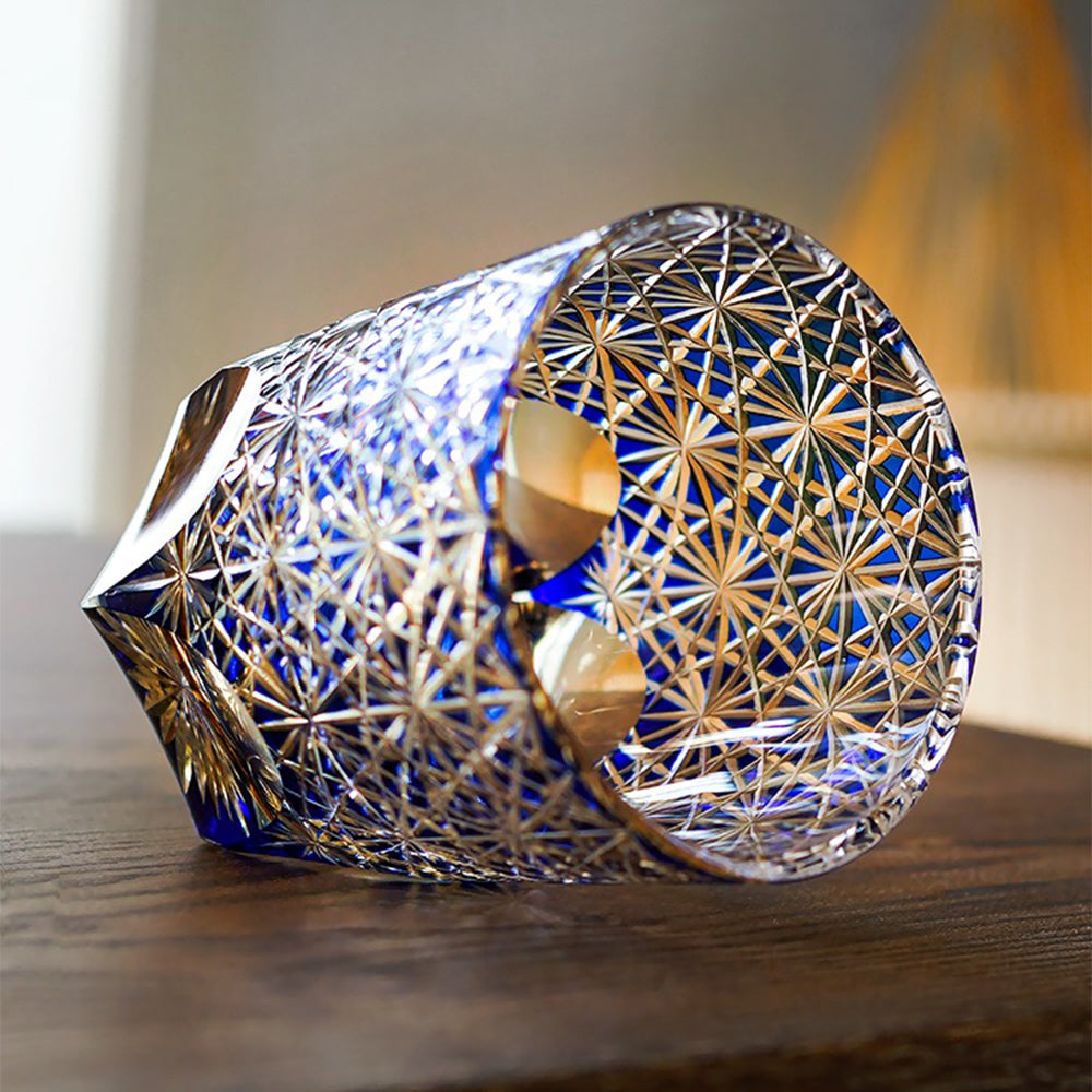 Wide-mouth whiskey glass highlighting the blue hue and intricate carvings