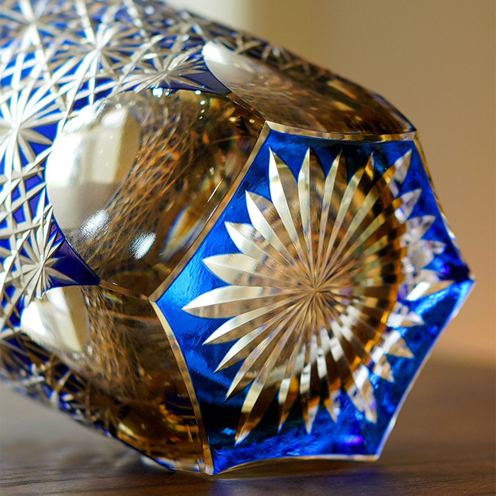 Wide-mouth whiskey glass highlighting the blue hue and intricate carvings