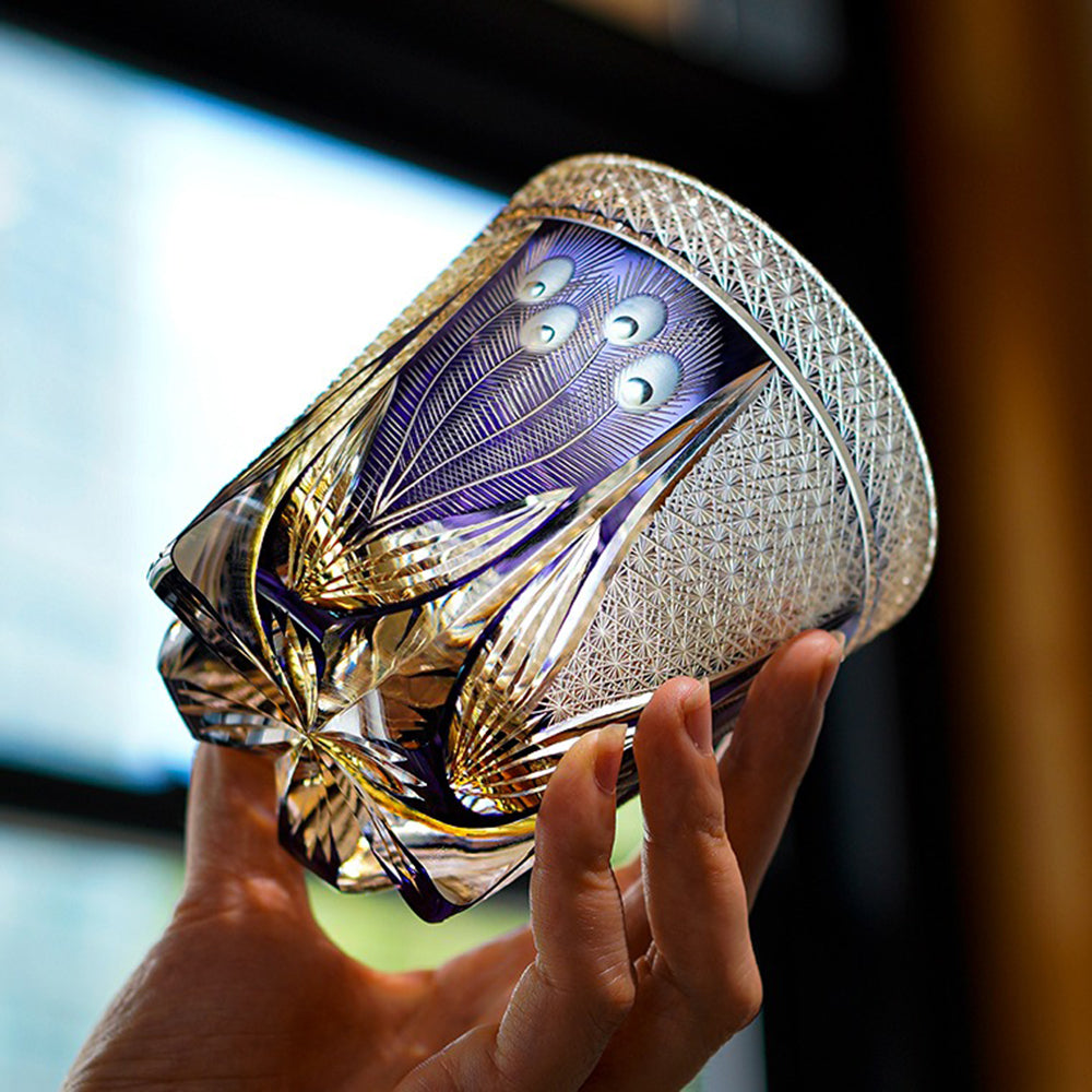 Side angle of crystal glass with thick base and elegant violet hue, ideal for whisky tasting.