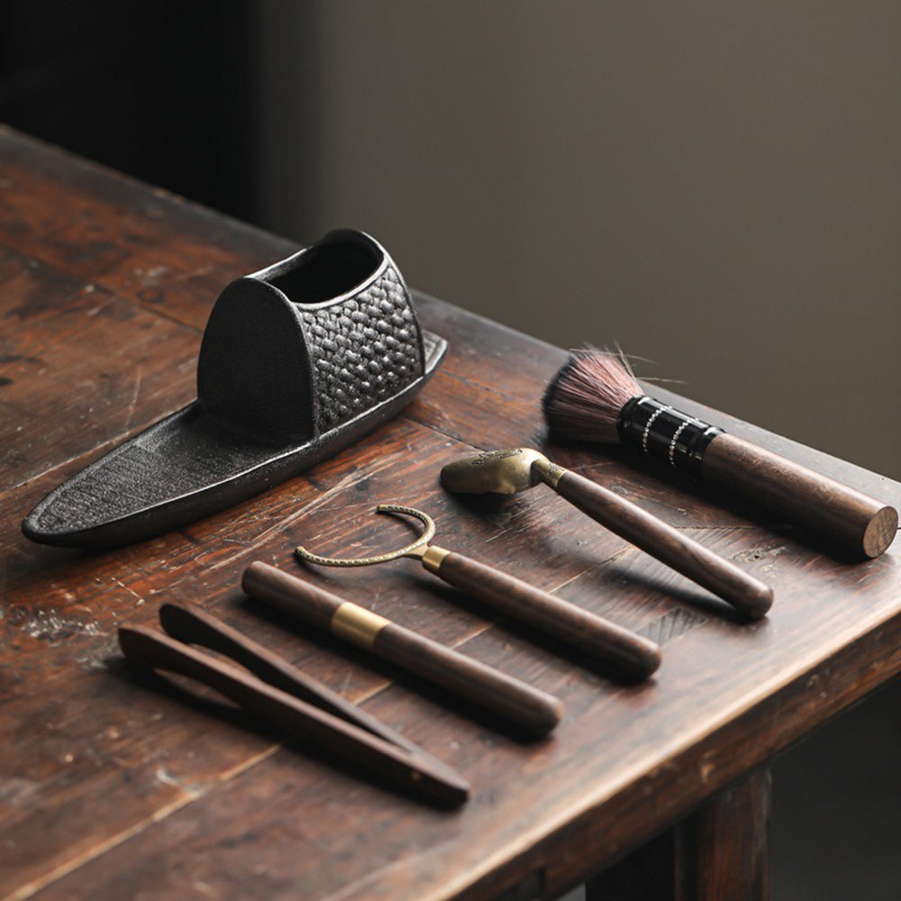 Tea tools from the set arranged on a wooden table during a tea ceremony