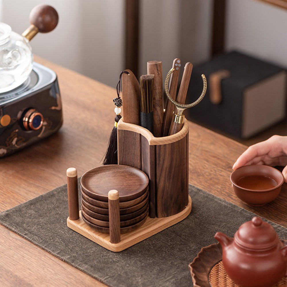 The full tea set displayed with all tea utensils neatly arranged next to six walnut wood coasters.