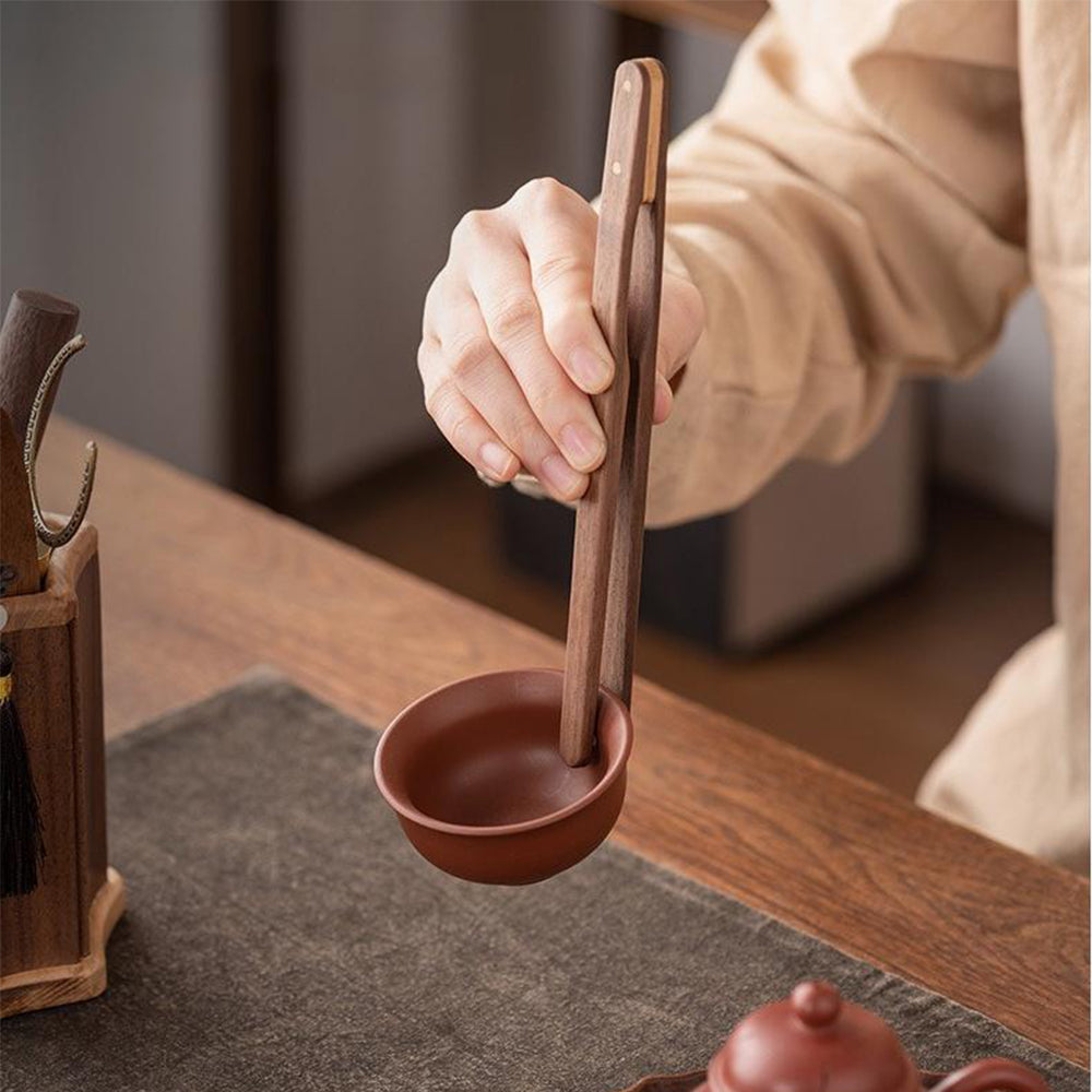 The full tea set displayed with all tea utensils neatly arranged next to six walnut wood coasters.
