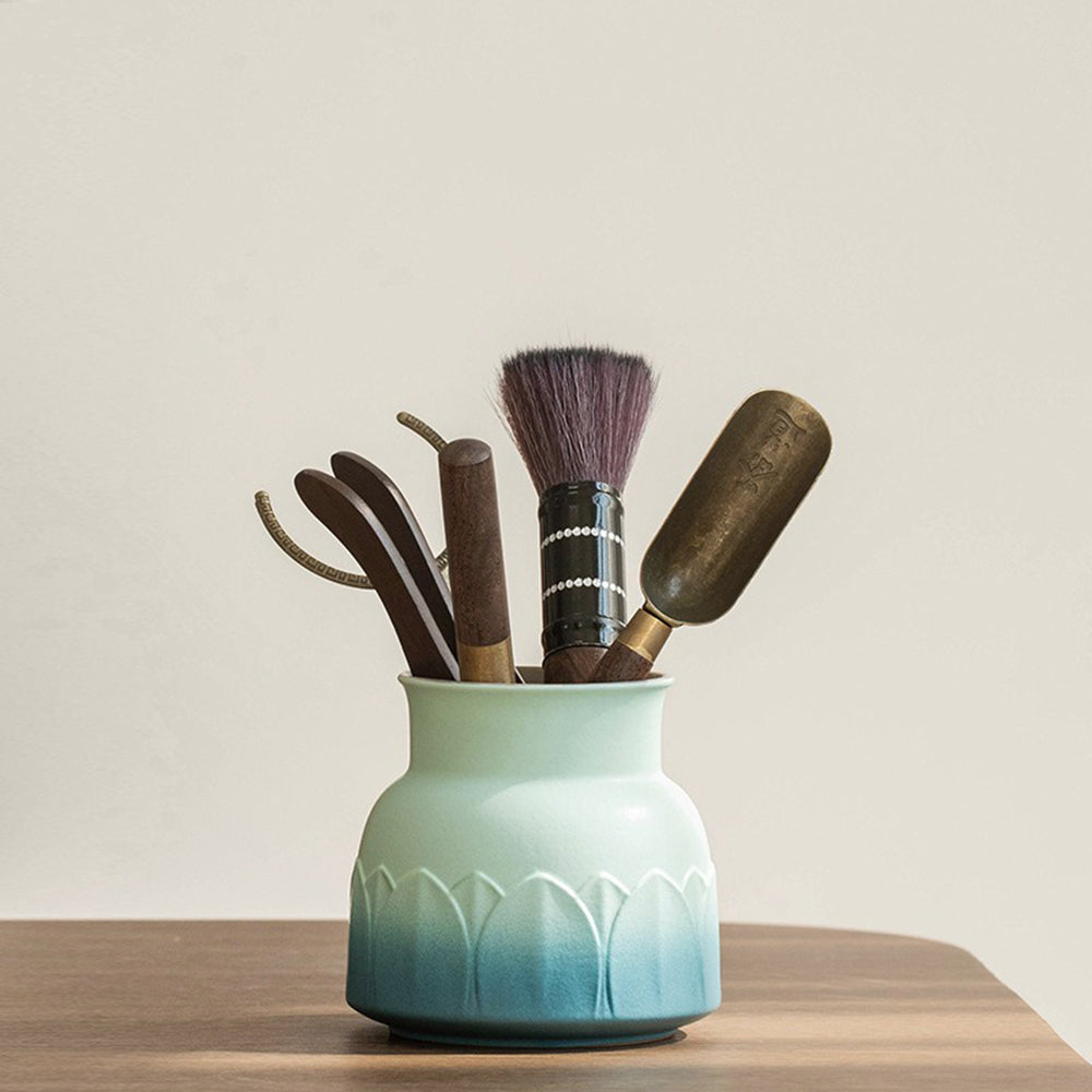 Elegant ebony tea utensils set displayed with lotus ceramic holder from above, showcasing the intricate design.