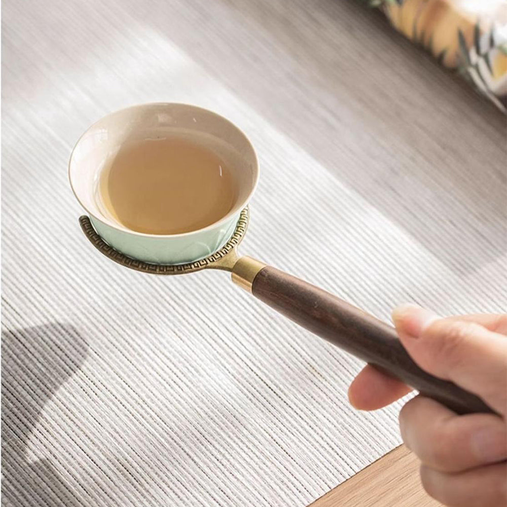 Elegant ebony tea utensils set displayed with lotus ceramic holder from above, showcasing the intricate design.