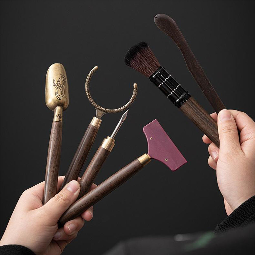 Complete tea accessories set displayed elegantly on a wooden table.