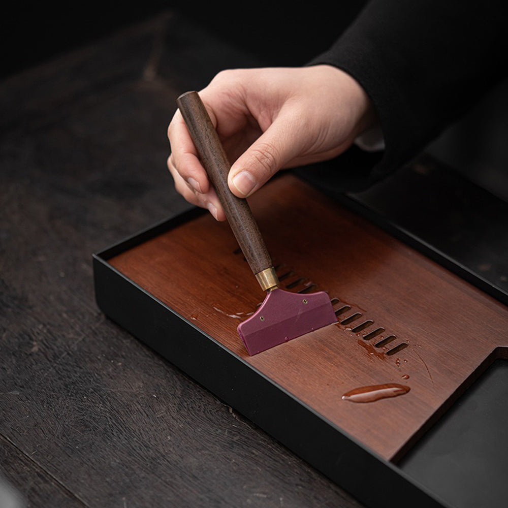Close-up view of the ebony tea utensils set showcasing the bronze glaze holder.