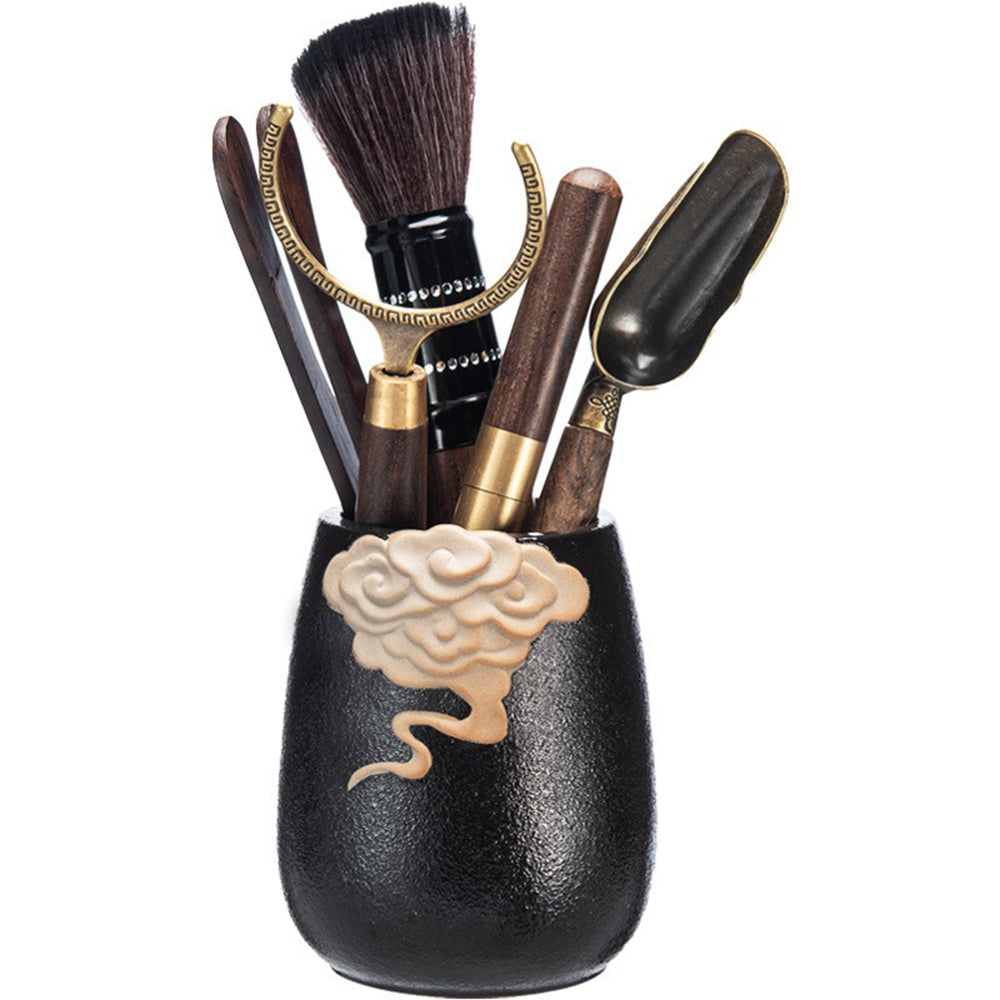 Close-up of ebony tea utensils set with copper details and auspicious clouds holder, showcasing craftsmanship