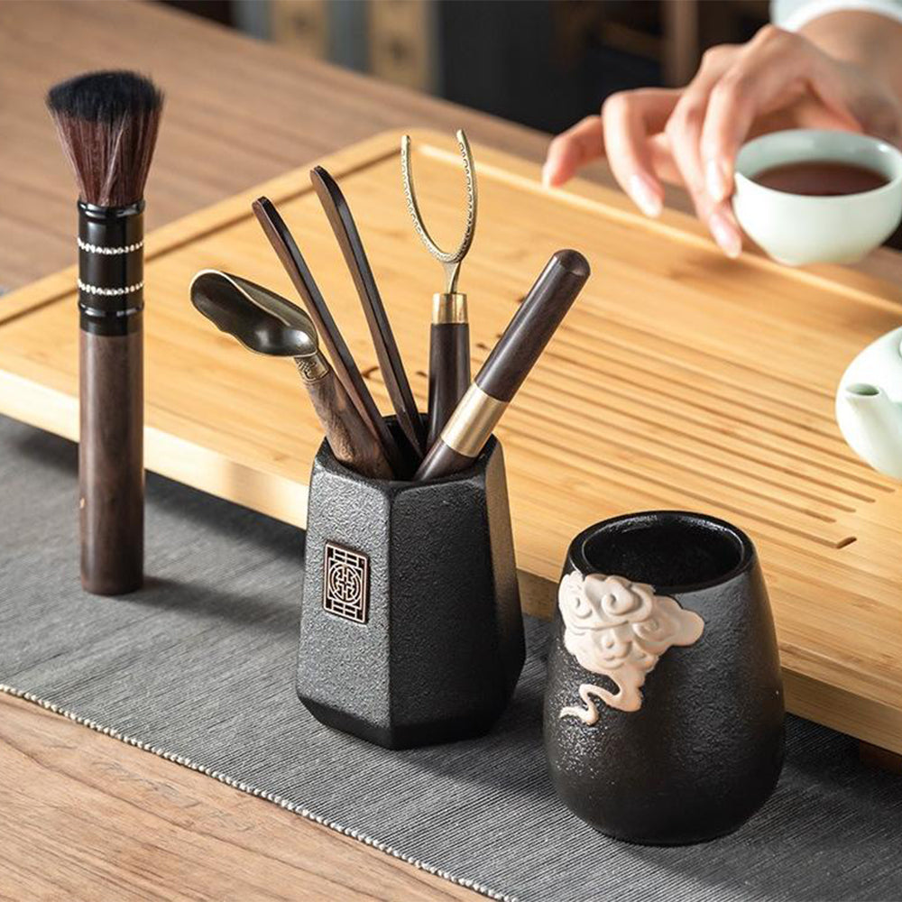Top view of the ebony tea utensils set with a focus on the auspicious clouds decorative pattern