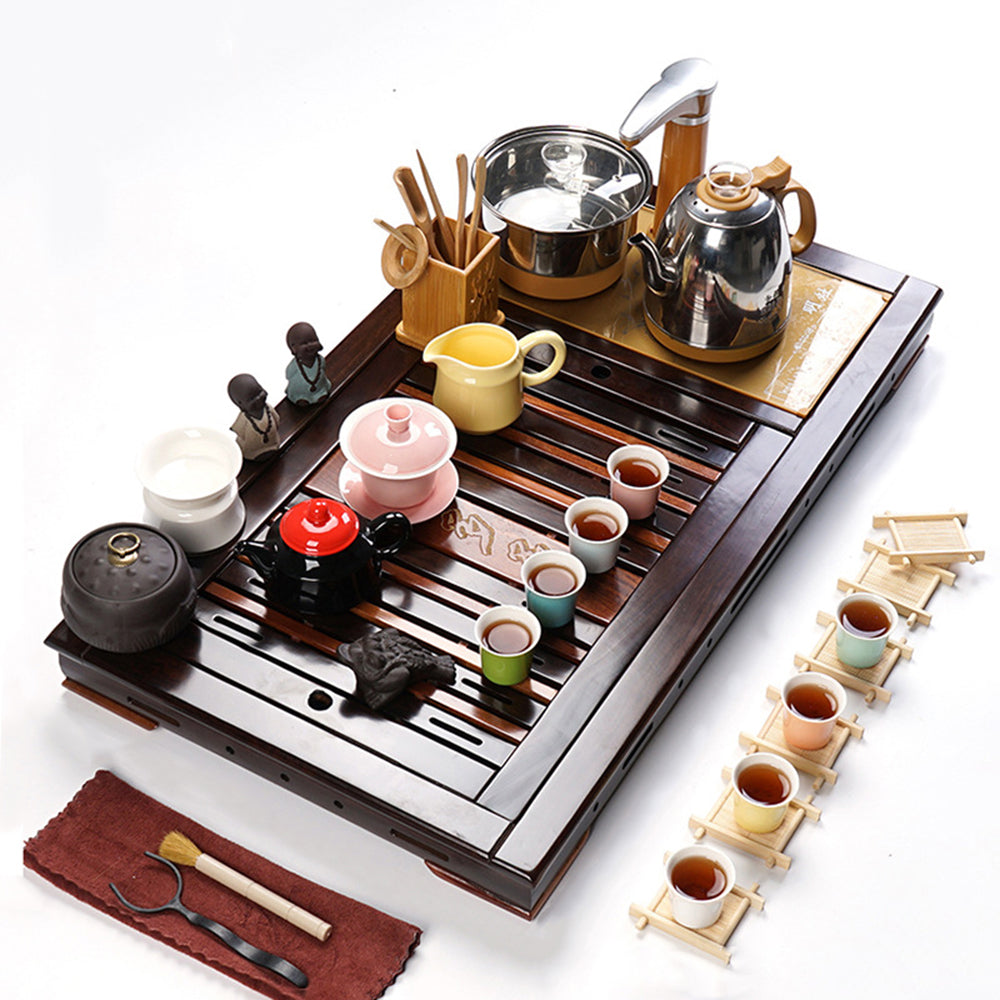 Vibrant ceramic tea set with rosewood ebony tray and induction cooker, perfect for tea ceremonies.