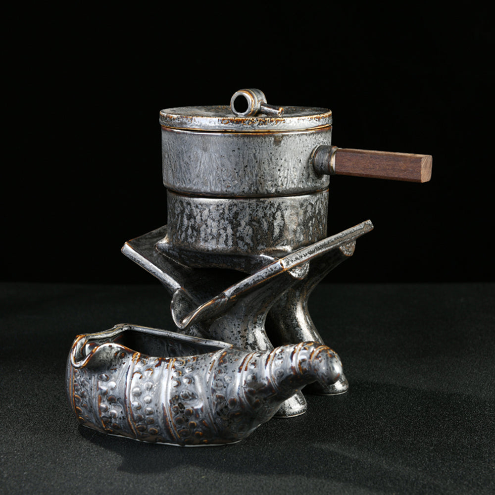 Detailed shot of the tea cups and tea pets arranged on the black stone tray, emphasizing craftsmanship