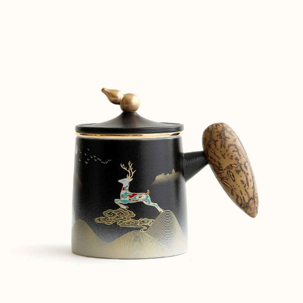 Close-up of ceramic tea mug with silver interior and gilded details, ideal for tea lovers