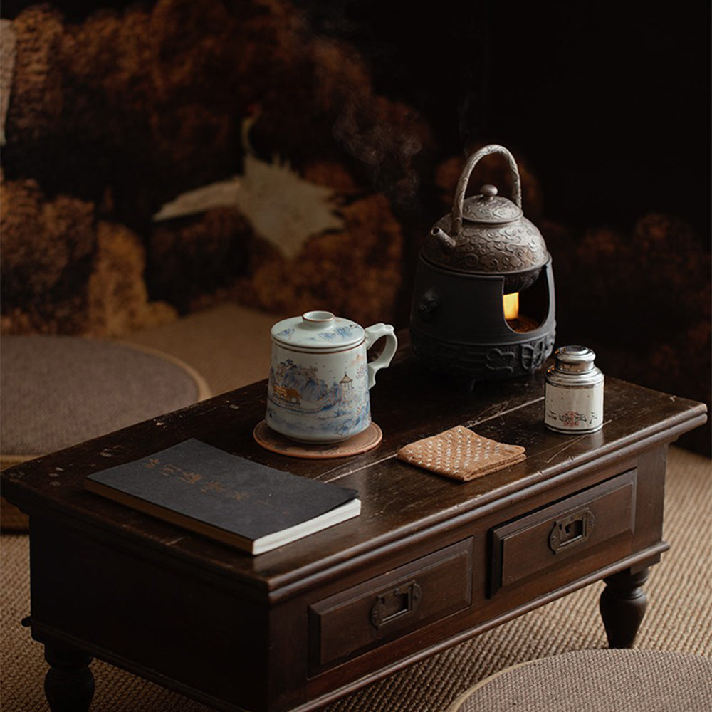The tea cup with infuser and gift box, showcasing its exquisite craftsmanship and traditional Chinese design