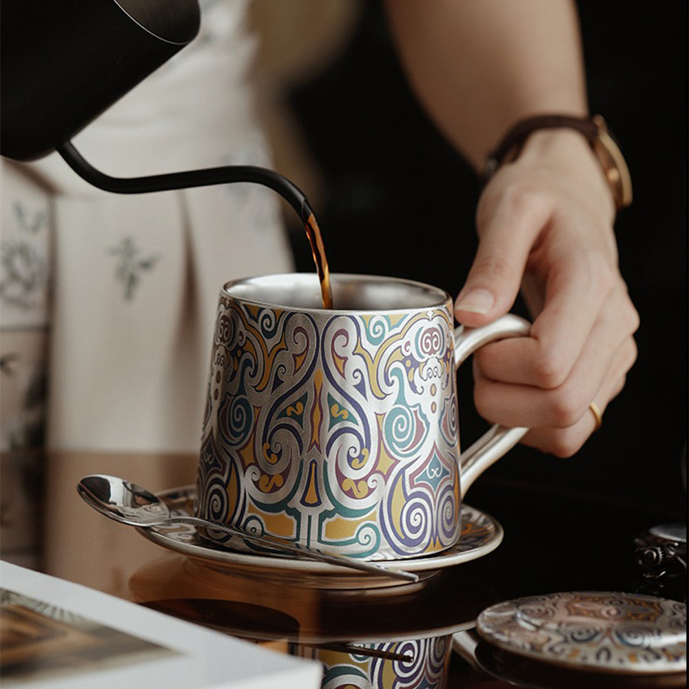 Tea cup with silver interior and comfortable handle, on a wooden table