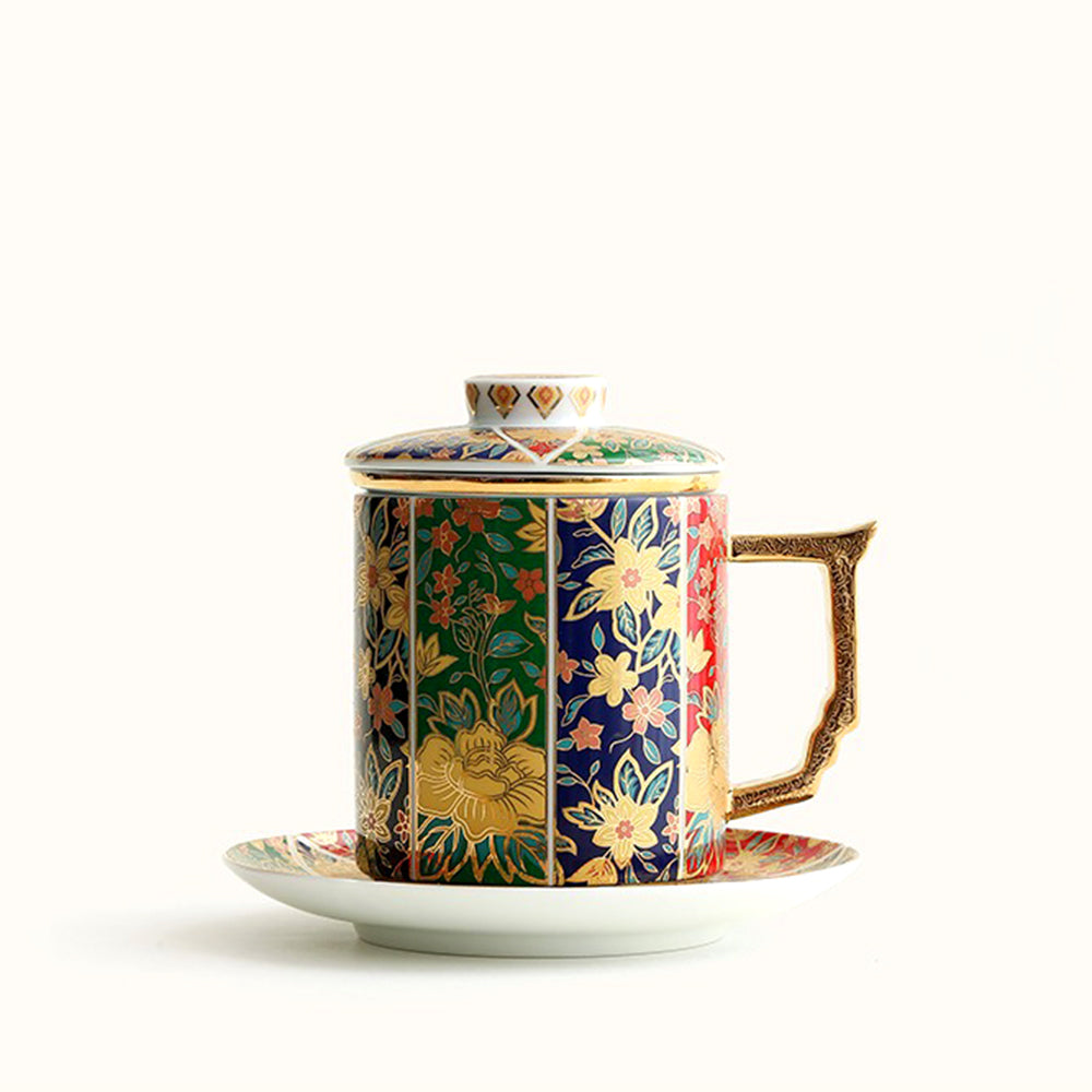 Close-up of gilded floral pattern on porcelain tea cup with vibrant enamel colors
