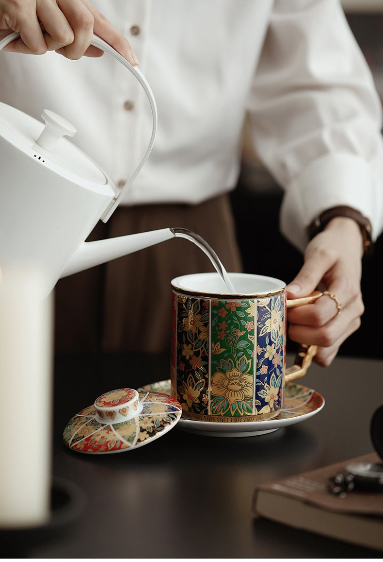 Elegant ceramic tea mug with embossed gilded handle on a wooden table