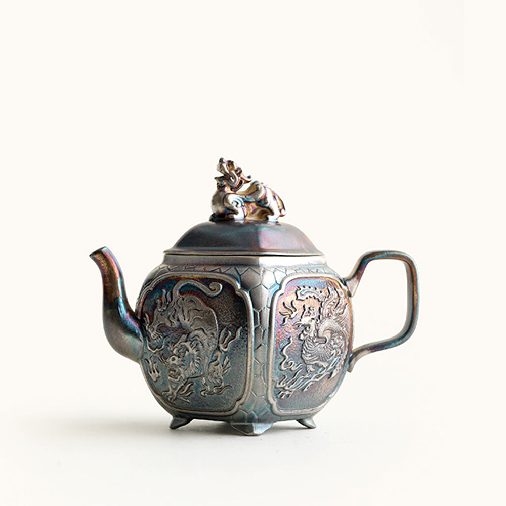 Close-up of the silver teapot with sacred beast design highlighting the intricate details.