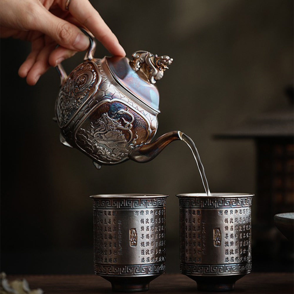 Close-up of the silver teapot with sacred beast design highlighting the intricate details.