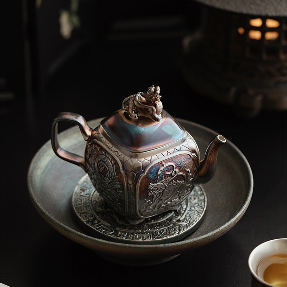 Silver teapot pouring tea smoothly, showcasing its practical use and stylish design.