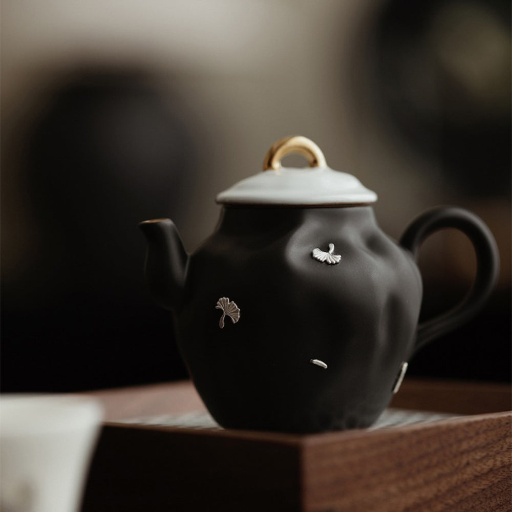 Close-up of the unique black teapots ginkgo leaf pattern.