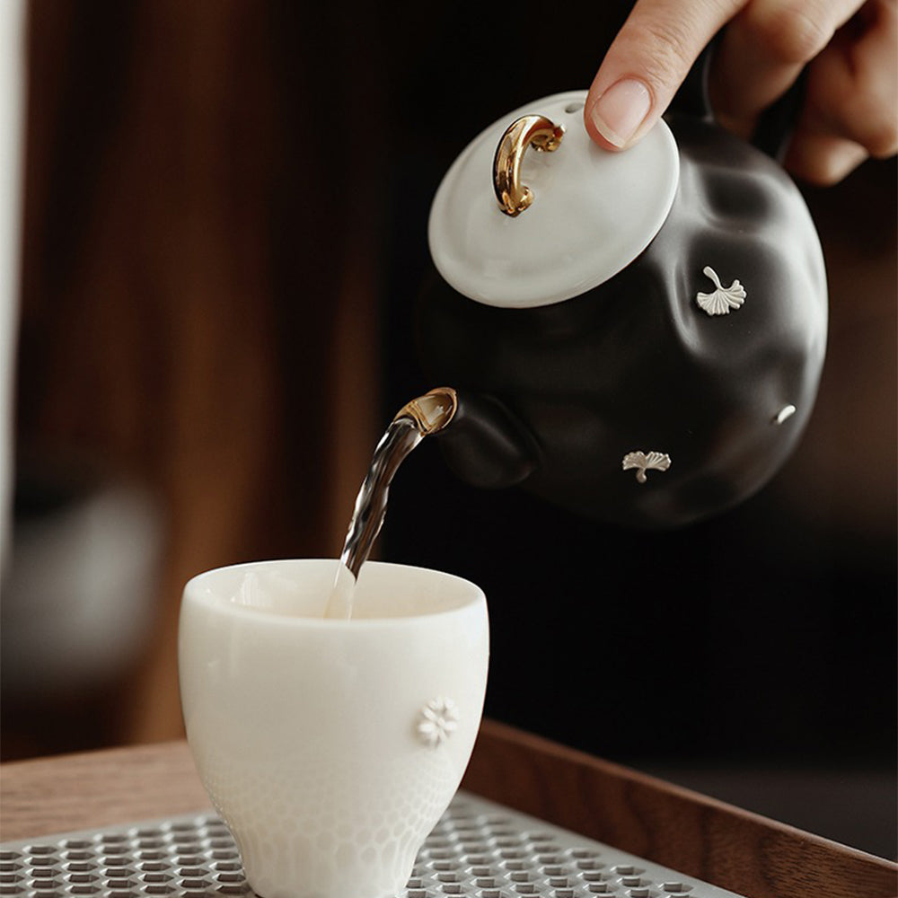 Close-up of the unique black teapots ginkgo leaf pattern.