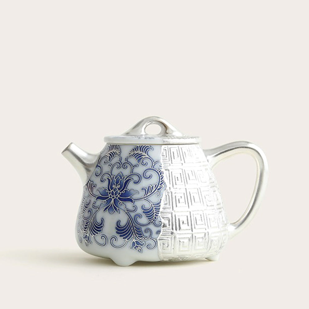 Elegant silver-plated blue and white Shi Piao teapot from a side angle, highlighting its intricate design.