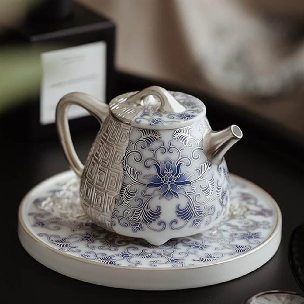A close-up of the teapots spout and handle, emphasizing the smooth finish and luxury silver plating.