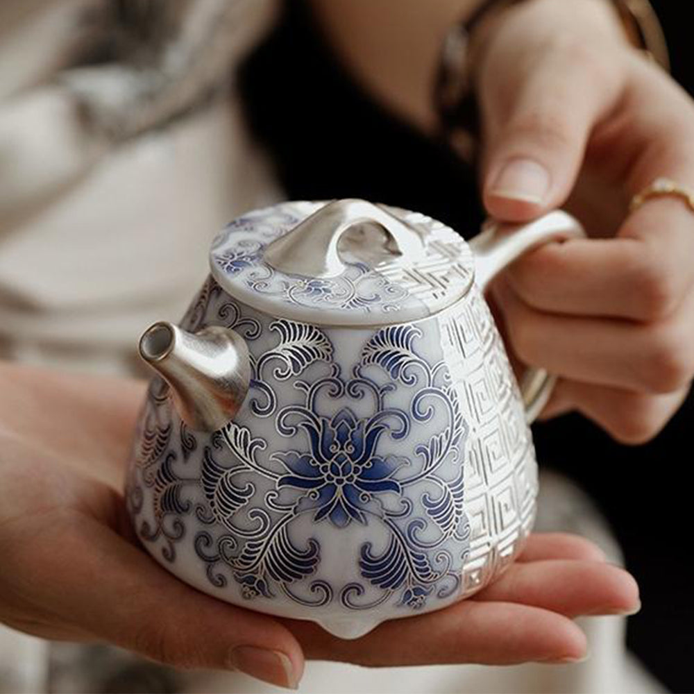 A close-up of the teapots spout and handle, emphasizing the smooth finish and luxury silver plating.