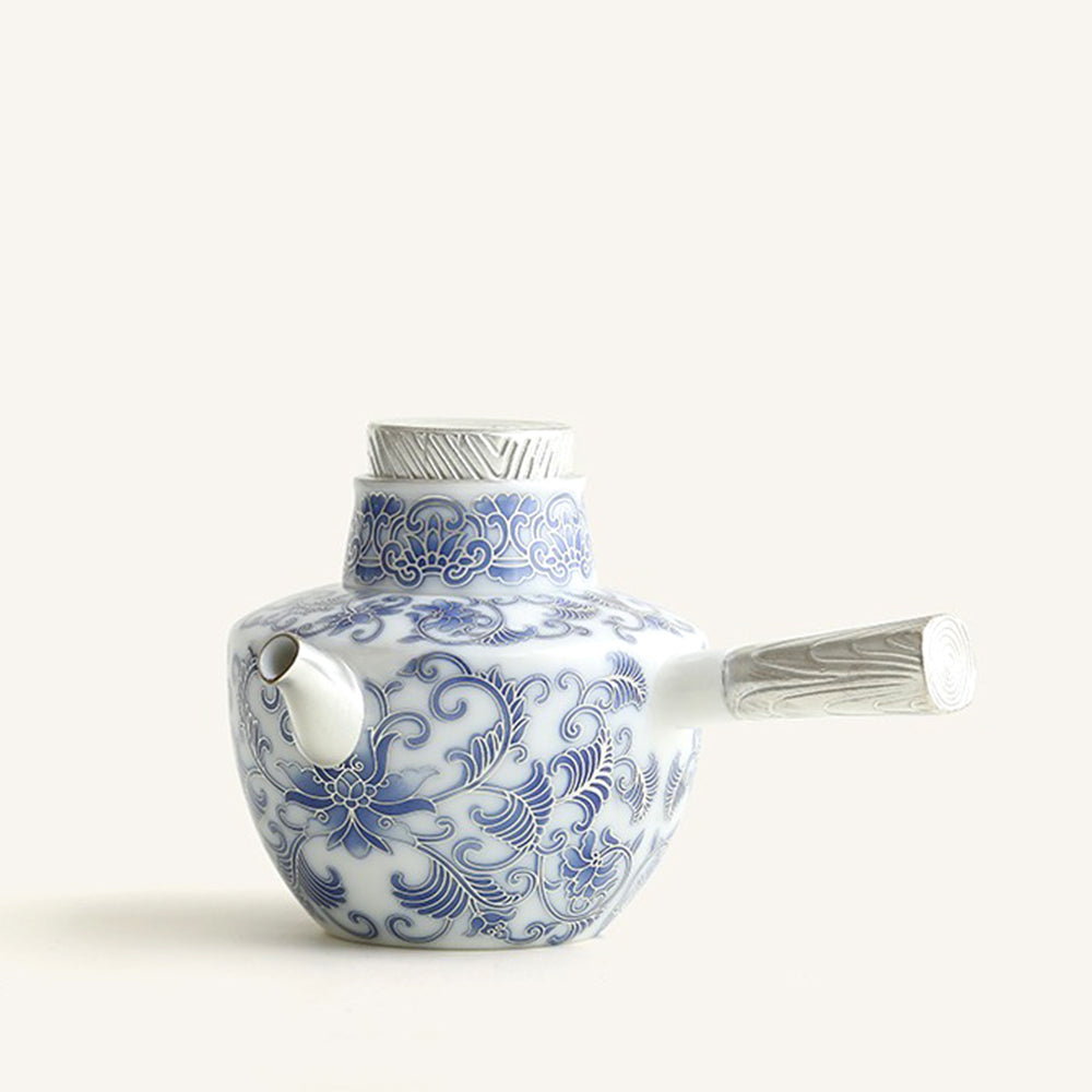 Blue and white porcelain teapot with side handle and intricate patterns