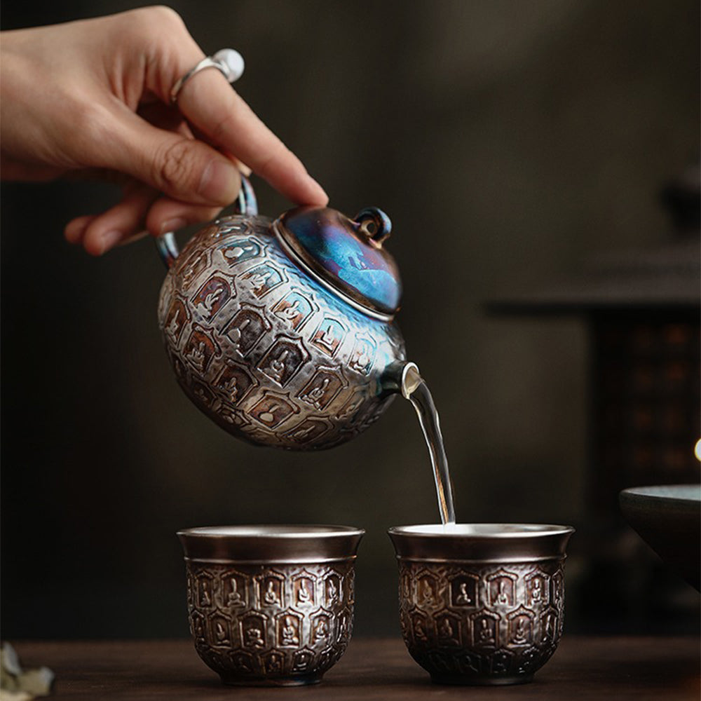 A colorful silver-plated ceramic Buddha teapot elegantly displayed in a gift box.