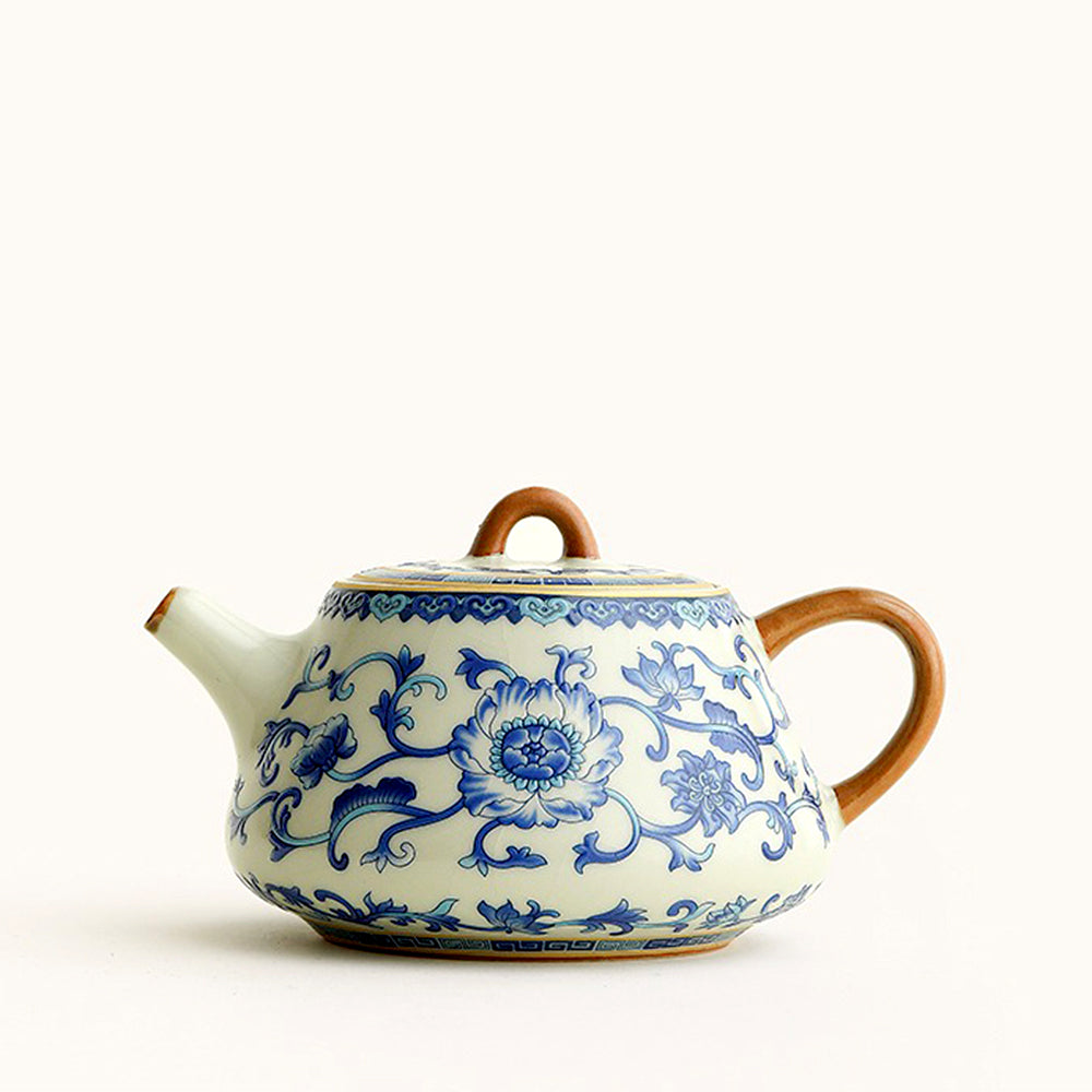 Elegant blue and white Ruyao teapot showcasing intricate designs from a side angle.