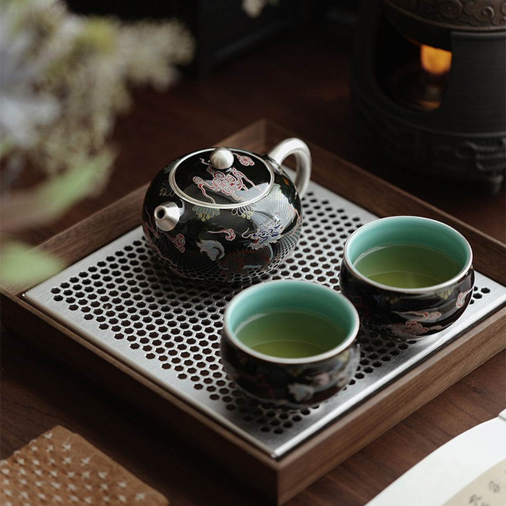 Elegant black teapot with Kirin design, showcasing smooth lines and intricate details.