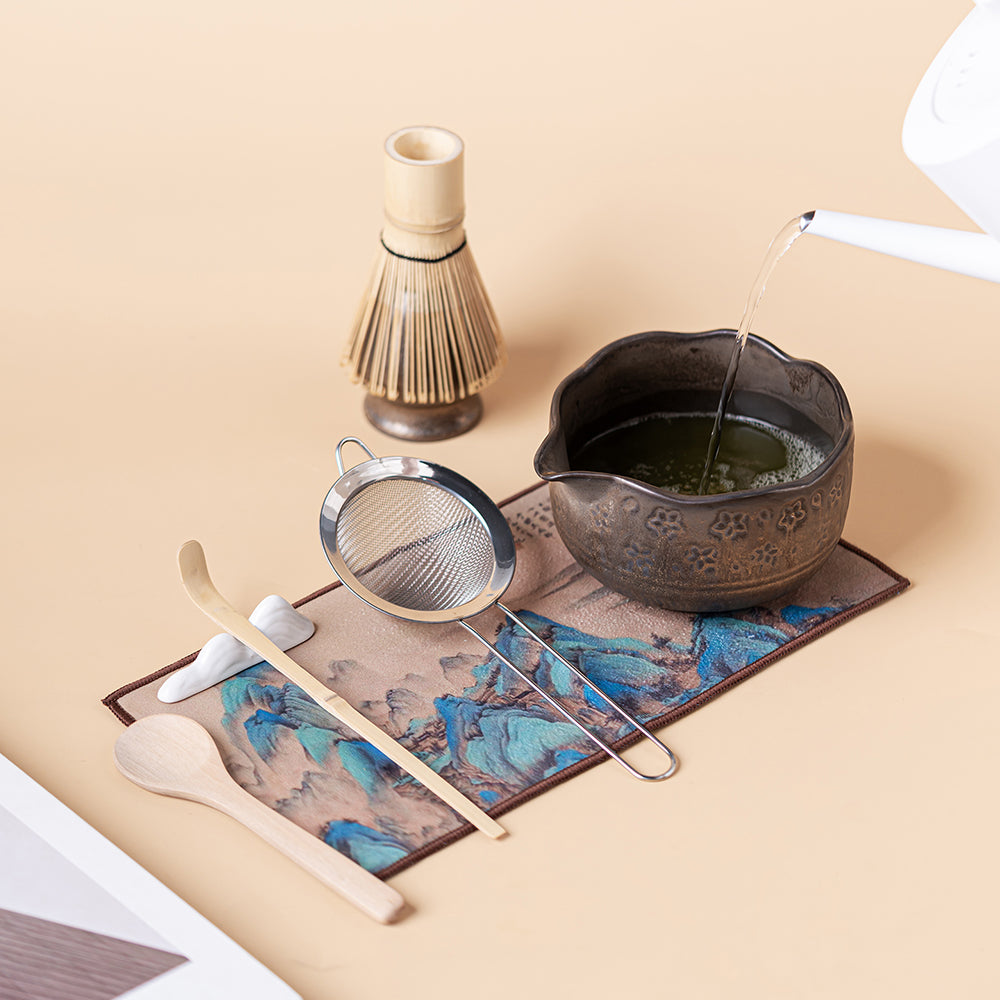 Traditional bamboo whisk and ceramic stand for tea ceremony