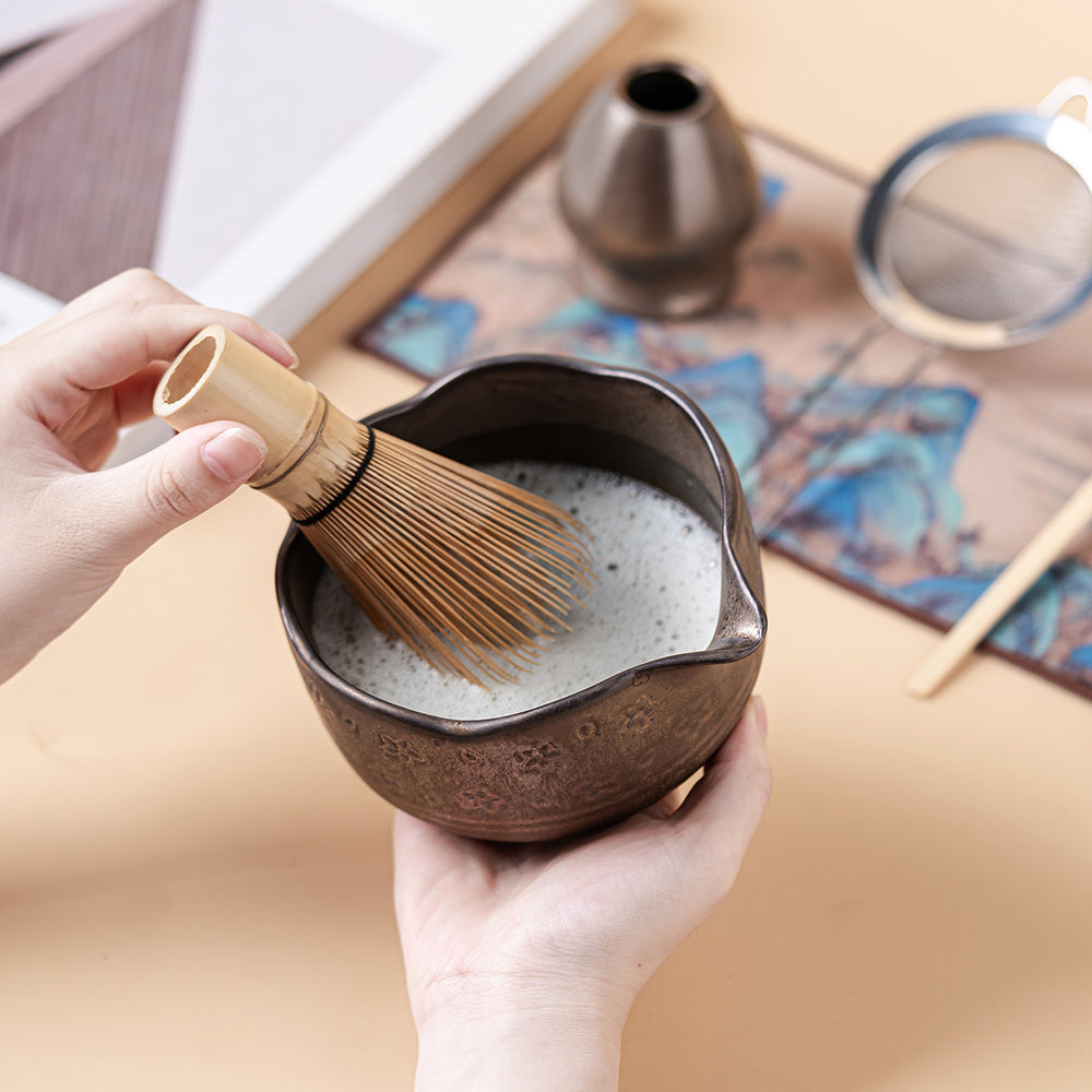 Set of matcha accessories including tea scoop, filter, and mug