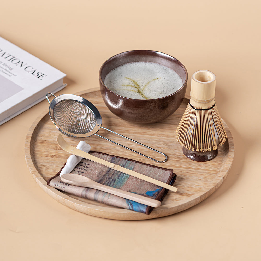 Traditional bamboo whisk and ceramic stand for tea ceremony
