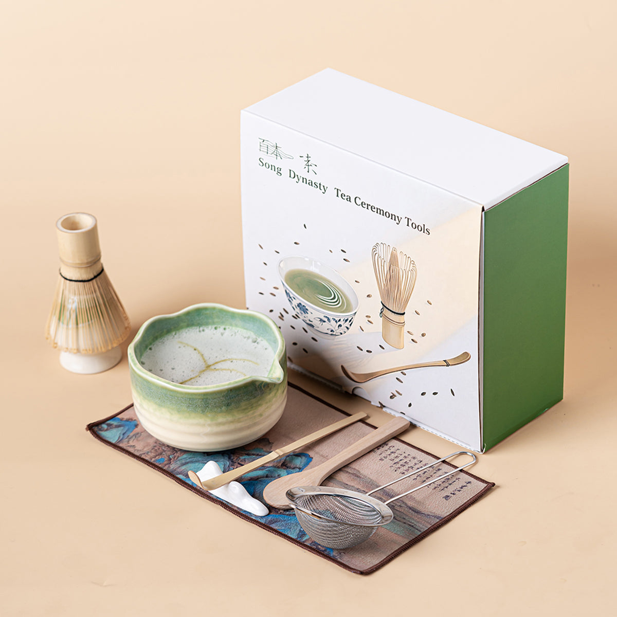 Close-up of kiln-glazed green matcha tea bowl with whisk