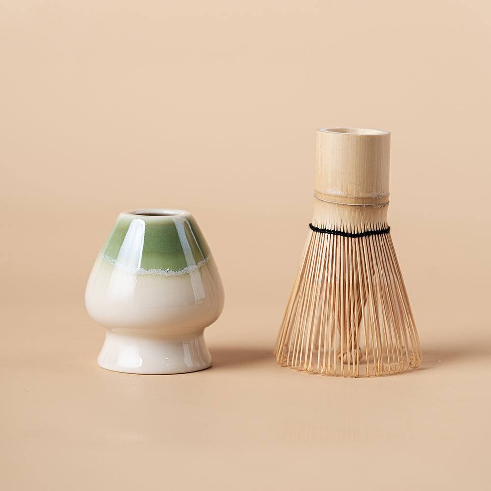 Preparation scene showing whisking matcha in ceramic bowl
