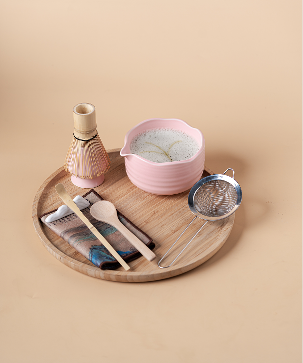 Close-up of the pink ceramic bowl and bamboo whisk, highlighting the quality of the matcha accessories.