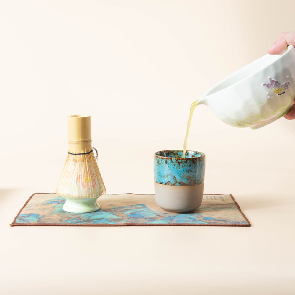 Close-up view of the elegant matcha tea bowl with floral and butterfly designs