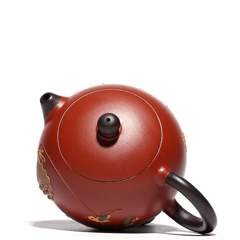 Yixing teapot in use, pouring tea into a cup, showcasing its functionality and elegance.