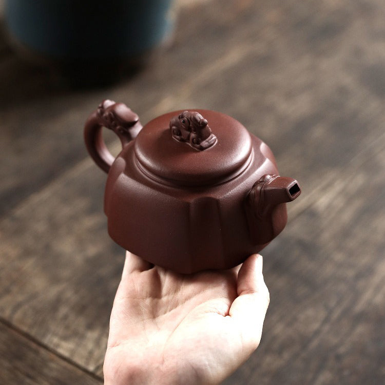 Elegant Yixing purple clay teapot showcasing its intricate dragon design and smooth finish.