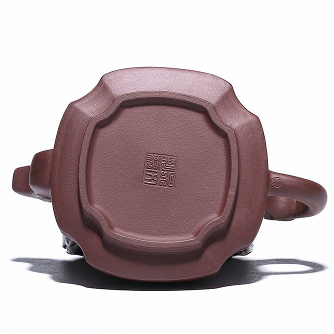 Yixing purple clay teapot in use, demonstrating its capacity and elegant design during a tea ceremony.