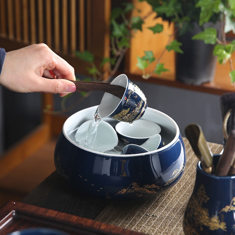 Close-up of a blue and white Chinese tea set, showcasing detailed craftsmanship and glossy finish